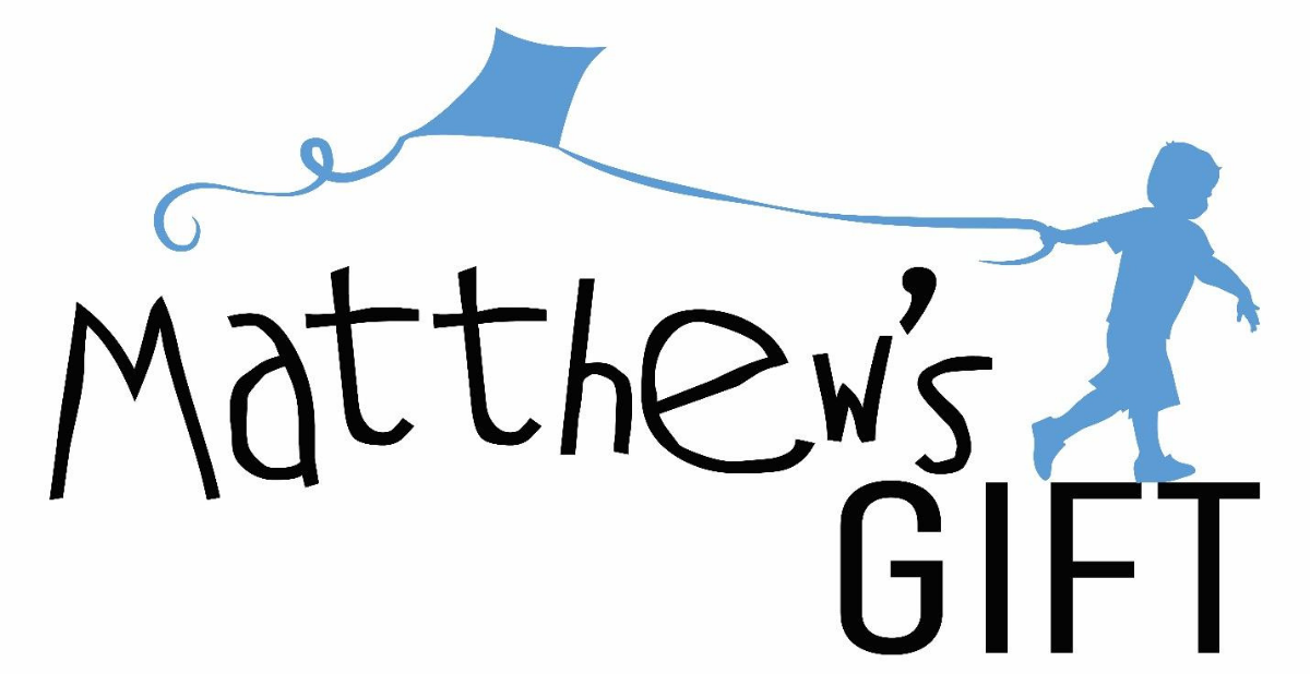 Little boy flying a kite above Matthew's Gift Project Title.